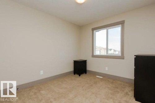 Carpeted flooring, single pane window, neutral wall paint, and recessed lighting - 7233 Armour Crescent Sw, Edmonton, AB 
