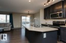 Kitchen island with integrated double basin sink and gooseneck faucet - 7233 Armour Crescent Sw, Edmonton, AB 