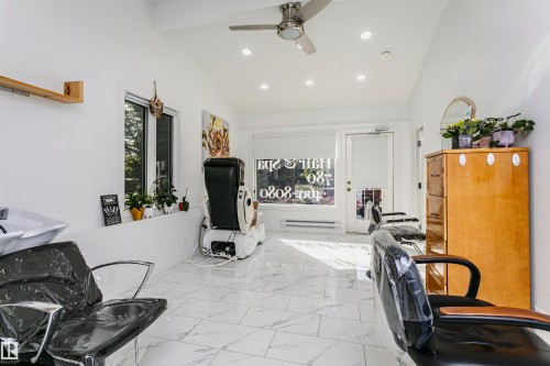 Vaulted ceilings with recessed lighting, white walls, and white laminate flooring - 7204 92B Avenue Nw, Edmonton, AB 