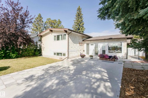 Stone-finish exterior with a gabled roofline and an attached awning - 7204 92B Avenue Nw, Edmonton, AB 
