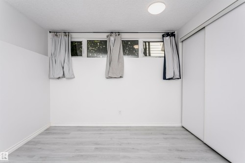 Recessed ceiling light fixture, wood-finish flooring, and white walls - 7204 92B Avenue Nw, Edmonton, AB 