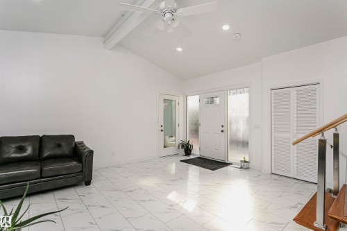 Vaulted ceiling with exposed beam, ceiling fan, recessed lighting, white laminate flooring, and louvered bifold closet doors - 7204 92B Avenue Nw, Edmonton, AB 