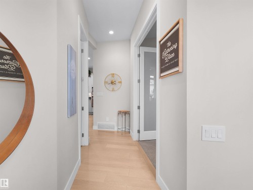 Hallway with light wood-finish flooring, white walls, and recessed lighting - 904 Wood Place Nw, Edmonton, AB 