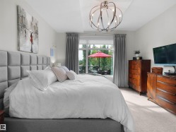 Recessed ceiling with an ornamental chandelier and wall-to-wall carpeting - 