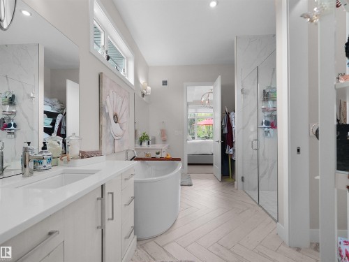 Dual vanity with undermount sinks, white cabinetry, and polished chrome fixtures - 904 Wood Place Nw, Edmonton, AB 