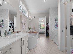Dual vanity with undermount sinks, white cabinetry, and polished chrome fixtures - 