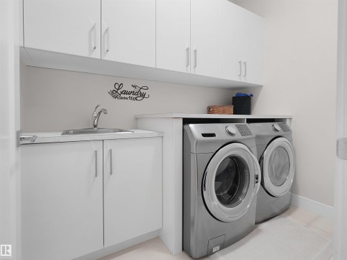 White cabinetry with brushed nickel hardware, integrated stainless steel sink, and built-in countertop - 904 Wood Place Nw, Edmonton, AB 