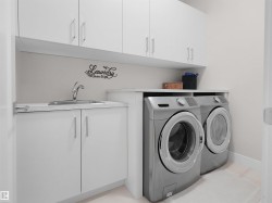 White cabinetry with brushed nickel hardware, integrated stainless steel sink, and built-in countertop - 