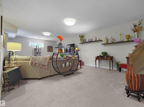 Expansive carpeted area with recessed lighting, multiple windows, and wall-mounted shelving - 904 Wood Place Nw, Edmonton, AB 