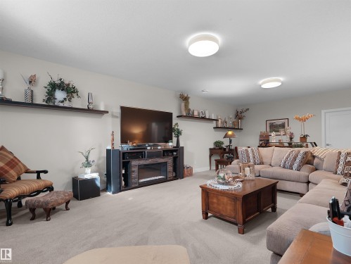 Recessed lighting, wall-mounted shelving, built-in entertainment center, and integrated electric fireplace - 904 Wood Place Nw, Edmonton, AB 