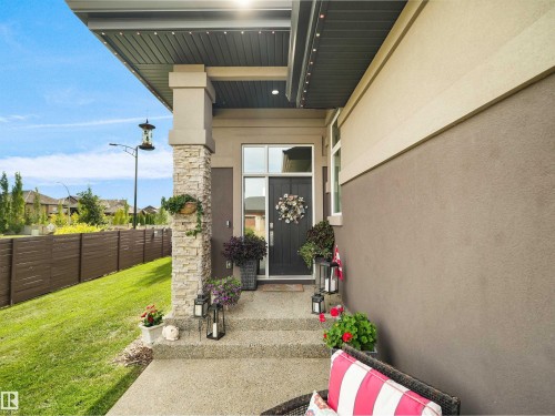 Covered front entry featuring a stone-clad column and concrete steps - 904 Wood Place Nw, Edmonton, AB 