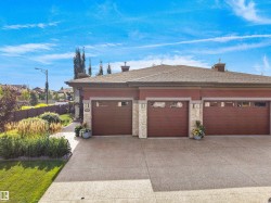 Three-car garage with wood-finish doors and transom windows - 