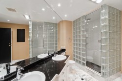 Dual vanity with undermount sinks and dark stone countertop - 