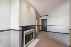 Recessed lighting, dark wood-finish mantel, fireplace with a metal insert, patterned wainscoting, and carpet flooring - 