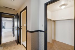 Hallway with dark trim, neutral walls, and recessed lighting - 
