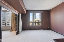 Wall-to-wall carpeting, expansive windows, and a glass-paneled balcony door - 
