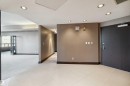 Recessed lighting, tile flooring, wall-mounted light fixtures, dark trim, and a door with security hardware - #12A 10050 118 St Nw, Edmonton, AB 