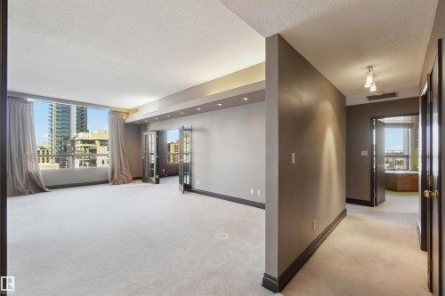 Wall-to-wall carpeting, recessed ceiling lighting, full-height windows, and French doors - #12A 10050 118 St Nw, Edmonton, AB 