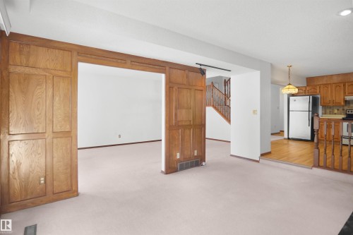 Wood-paneled room divider with an open doorway - 12311 25 Avenue Nw, Edmonton, AB 