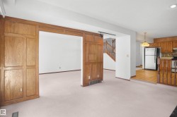 Wood-paneled room divider with an open doorway - 