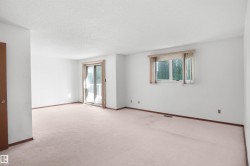 Bright interior space featuring a sliding glass door with balcony access and a secondary window - 