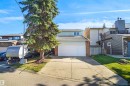 Integrated garage with a white door, brick-detailed exterior, and light-colored siding - 12311 25 Avenue Nw, Edmonton, AB 