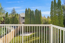 Expansive backyard featuring a manicured lawn, mature trees, and a privacy fence - 