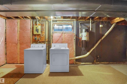 Dedicated laundry area with a washer and dryer - 12311 25 Avenue Nw, Edmonton, AB 