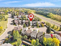 Residential neighborhood with mature trees, paved roads, and nearby major roadway - 