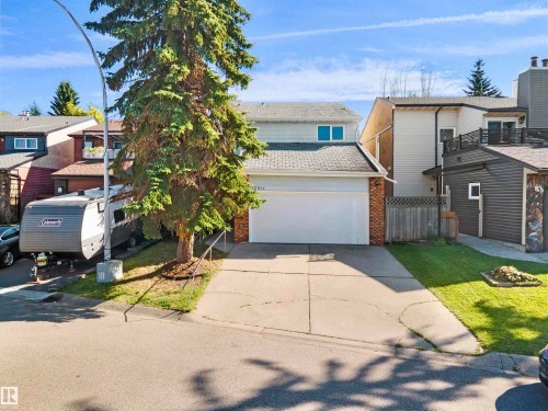 Two-story residence featuring light-colored siding and a two-car garage - 12311 25 Avenue Nw, Edmonton, AB 