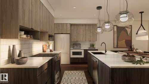 Sleek kitchen featuring wood-finish cabinetry, white countertops, integrated stainless steel appliances, and pendant lighting fixtures - 20 Clichy Close, St. Albert, AB 