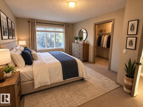 Carpeted bedroom featuring a large window, recessed lighting, and a walk-in closet with built-in shelving - 7065 Cardinal Way Sw, Edmonton, AB 