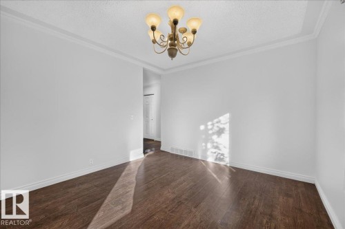 Recessed lighting, crown molding, wood-finish flooring, and a decorative chandelier - 8 Wahstao Crescent Nw, Edmonton, AB 