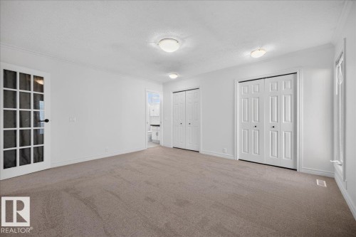 Textured carpeting, white walls, and three ceiling-mounted light fixtures - 8 Wahstao Crescent Nw, Edmonton, AB 