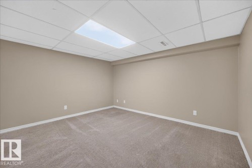 Recessed lighting, neutral wall paint, light-toned carpet, and a drop ceiling - 8 Wahstao Crescent Nw, Edmonton, AB 