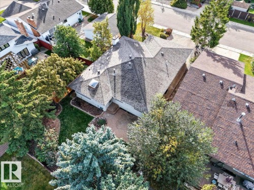 Asphalt shingle roofing, skylight, paver patio, stone landscaping, and established trees - 8 Wahstao Crescent Nw, Edmonton, AB 