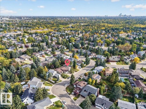 Residential neighborhood with mature trees, established streets, and distant city skyline - 8 Wahstao Crescent Nw, Edmonton, AB 