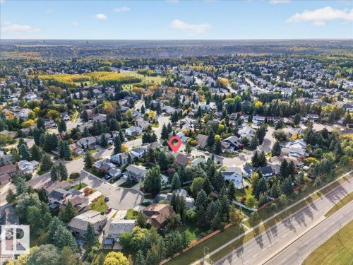 Residential neighborhood with mature trees, established homes, and an adjacent multi-lane roadway - 8 Wahstao Crescent Nw, Edmonton, AB 