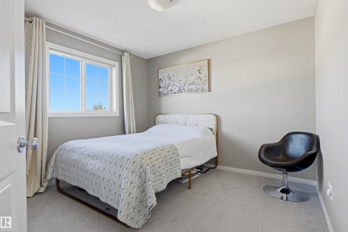 Light-toned carpeting, neutral wall color, and a window with white trim - 3151 Trelle Loop Nw, Edmonton, AB 