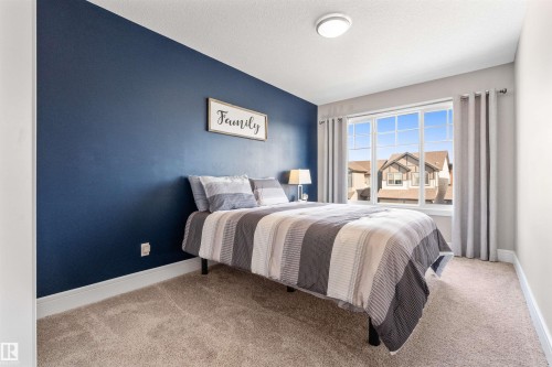 Recessed ceiling light fixture, large window, carpeted flooring, and accent wall - 3334 Parker Loop Sw, Edmonton, AB 