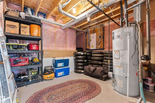 Unfinished basement space with exposed ceiling joists and visible insulation - 3334 Parker Loop Sw, Edmonton, AB 