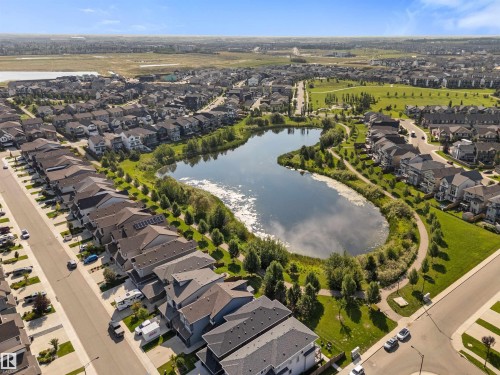 Aerial perspective of a developed residential area with a central pond - 3334 Parker Loop Sw, Edmonton, AB 