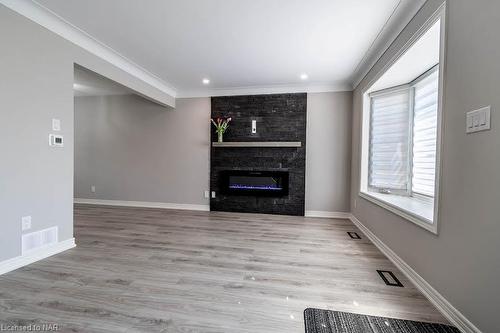 B-261 Scott Street, St. Catharines, ON - Indoor Photo Showing Other Room With Fireplace