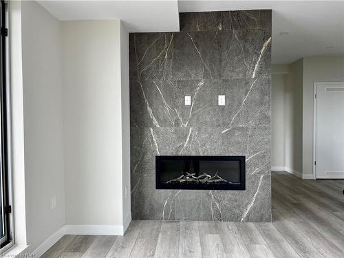 801-118 West Street, Port Colborne, ON - Indoor Photo Showing Living Room With Fireplace