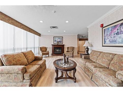 607-5070 Pinedale Avenue, Burlington, ON - Indoor Photo Showing Living Room With Fireplace