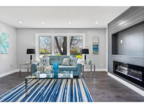 Upper-8235 Paddock Trail Drive, Niagara Falls, ON - Indoor Photo Showing Living Room With Fireplace