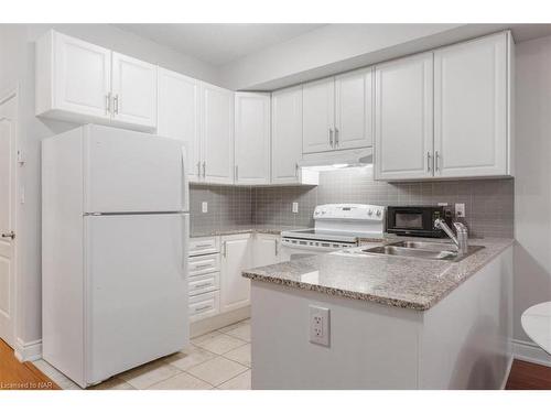 320-8111 Forest Glen Drive, Niagara Falls, ON - Indoor Photo Showing Kitchen With Double Sink