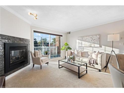 205-70 Main Street, St. Catharines, ON - Indoor Photo Showing Living Room With Fireplace