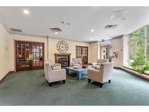 225-8111 Forest Glen Drive, Niagara Falls, ON - Indoor Photo Showing Living Room With Fireplace