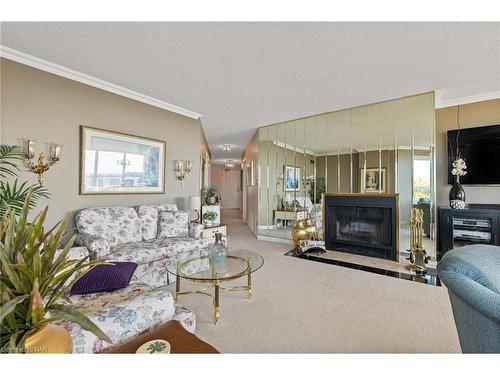 13O3-701 Geneva Street, St. Catharines, ON - Indoor Photo Showing Living Room With Fireplace